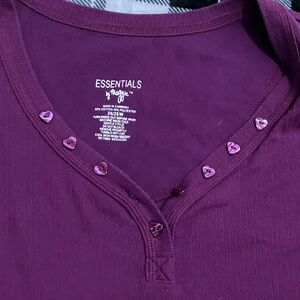 purple T-shirt with heart buttons and a V neck.